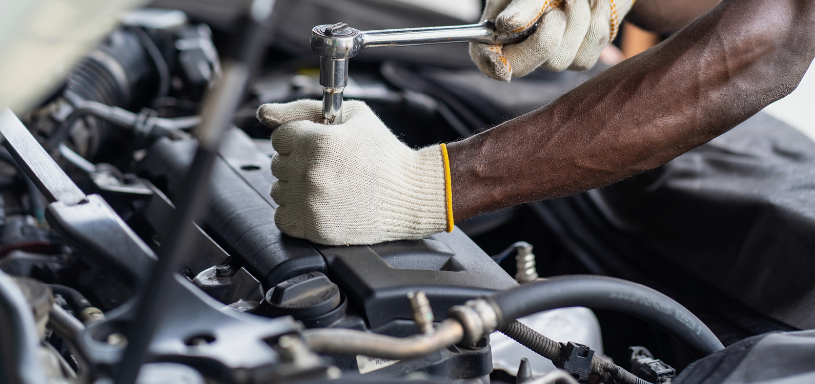 Mechanic hands working on an engine